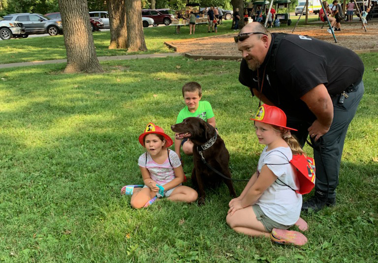 SRO Nielsen and K9 Camo at National Night Out interacting with children