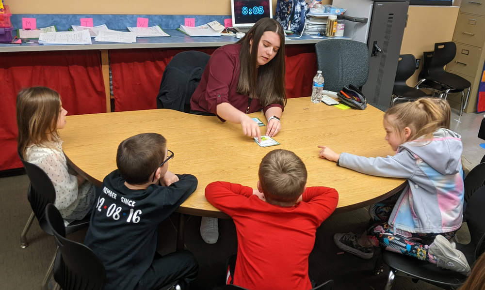 Student Teacher Tailor Kelty works on reading skills with Skelly students