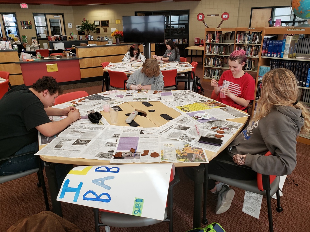 students painting ornaments in the library