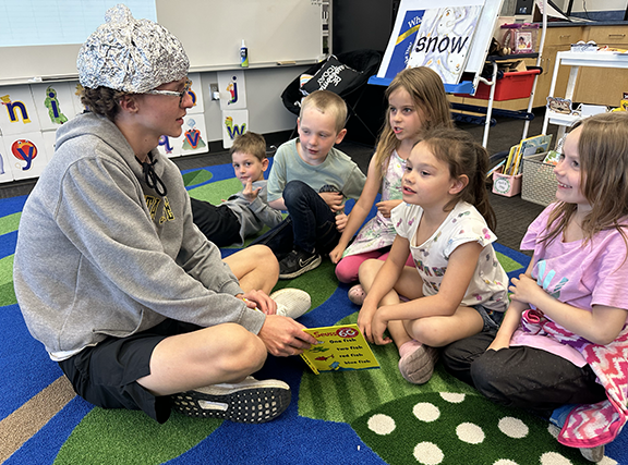 prom king candidate reading to Blackmore students
